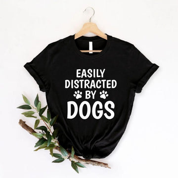 Perfect for dog lovers, pet parents, puppy owners and animal enthusiasts, this Easily Distracted by Dogs shirt features bold typography with adorable paw prints, making it a fun everyday choice. Whether you're walking your dog, visiting the park or relaxing with your favourite companion, this premium graphic tee offers lasting comfort. Professionally printed in the UK by TeezoraPrints using high-quality materials.
