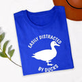 Searching for the perfect gift for a duck lover? This Easily Distracted by Ducks shirt is a fun choice for birthdays, Christmas, Mother's Day, Father's Day or any special occasion. Featuring a striking duck silhouette and humorous slogan, every premium shirt is professionally printed in the UK by TeezoraPrints for a thoughtful and memorable gift.