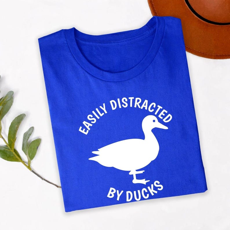 Searching for the perfect gift for a duck lover? This Easily Distracted by Ducks shirt is a fun choice for birthdays, Christmas, Mother's Day, Father's Day or any special occasion. Featuring a striking duck silhouette and humorous slogan, every premium shirt is professionally printed in the UK by TeezoraPrints for a thoughtful and memorable gift.