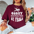 Show your passion for frogs with this Easily Distracted by Frogs graphic t-shirt featuring a striking frog illustration and bold retro lettering. The premium cotton fabric and comfortable unisex fit make it perfect for everyday wear, outdoor adventures and nature lovers. Every order is made to order and professionally printed in the UK by TeezoraPrints for exceptional quality.