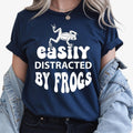 Easily Distracted by Frogs shirt, funny frog lover t shirt, amphibian lover tee, wildlife graphic shirt, nature lover apparel, frog enthusiast clothing, outdoor adventure tee, pond life shirt, novelty animal t shirt and casual wildlife fashion. Every premium shirt is proudly printed in the UK by TeezoraPrints for comfort, durability and professional quality.