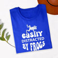 Searching for the perfect gift for a frog lover? This Easily Distracted by Frogs shirt is a thoughtful choice for birthdays, Christmas, Mother's Day, Father's Day or any special occasion. Featuring a detailed frog graphic and humorous slogan, every premium shirt is professionally printed in the UK by TeezoraPrints for a memorable and unique gift.