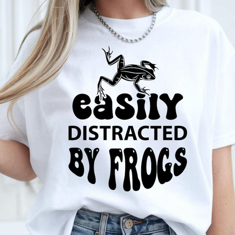 Perfect for frog lovers, amphibian enthusiasts, wildlife fans and nature explorers, this Easily Distracted by Frogs shirt features a bold frog illustration with retro-inspired typography for a fun everyday look. Whether you're exploring forests, visiting ponds or enjoying outdoor adventures, this premium t-shirt offers exceptional comfort. Professionally printed in the UK by TeezoraPrints using premium-quality materials.