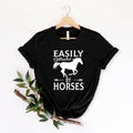 Celebrate your love for horses with this Easily Distracted by Horses shirt featuring a running horse silhouette and bold typography. Whether you're riding, caring for horses, exploring the countryside or spending time at the barn, this premium t-shirt delivers comfort and timeless style. Every shirt is proudly printed in the UK by TeezoraPrints.