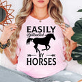 Funny horse lover shirt designed for equestrians, horse riders, ranch owners, stable workers and country lifestyle enthusiasts. Perfect for riding schools, equestrian competitions, horse shows, farm visits and outdoor adventures. Every premium graphic t-shirt is professionally printed in the UK by TeezoraPrints, delivering vibrant print quality and long-lasting comfort.