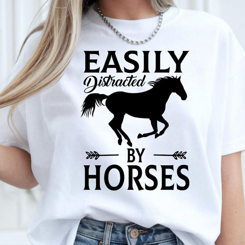 Perfect for horse lovers, equestrians, riders and stable owners, this Easily Distracted by Horses shirt features a striking running horse silhouette with bold typography that captures every equine enthusiast's personality. Whether you're spending time at the stables or enjoying country life, this premium t-shirt offers exceptional comfort. Every shirt is professionally printed in the UK by TeezoraPrints using premium-quality materials.