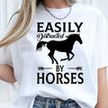 Perfect for horse lovers, equestrians, riders and stable owners, this Easily Distracted by Horses shirt features a striking running horse silhouette with bold typography that captures every equine enthusiast's personality. Whether you're spending time at the stables or enjoying country life, this premium t-shirt offers exceptional comfort. Every shirt is professionally printed in the UK by TeezoraPrints using premium-quality materials.