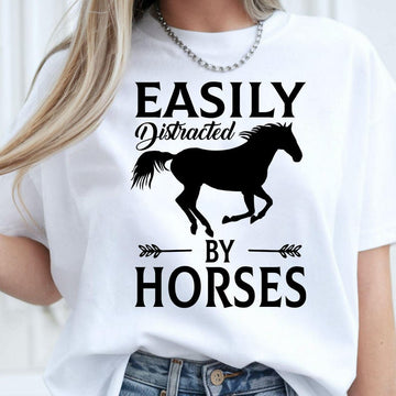 Perfect for horse lovers, equestrians, riders and stable owners, this Easily Distracted by Horses shirt features a striking running horse silhouette with bold typography that captures every equine enthusiast's personality. Whether you're spending time at the stables or enjoying country life, this premium t-shirt offers exceptional comfort. Every shirt is professionally printed in the UK by TeezoraPrints using premium-quality materials.
