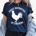 Looking for the perfect gift for someone who loves chickens and country life? This Easily Distracted By Chickens T Shirt from Teezora Prints features a bold rooster silhouette with eye-catching typography that every poultry lover will instantly appreciate. Professionally printed on a premium quality unisex t shirt, it delivers outstanding comfort, durability, and timeless style. Perfect for birthdays, Christmas, Mother's Day, Father's Day, farm visits, homestead life, and thoughtful gifts for chicken keeper