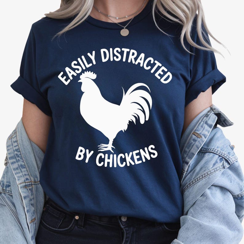 Looking for the perfect gift for someone who loves chickens and country life? This Easily Distracted By Chickens T Shirt from Teezora Prints features a bold rooster silhouette with eye-catching typography that every poultry lover will instantly appreciate. Professionally printed on a premium quality unisex t shirt, it delivers outstanding comfort, durability, and timeless style. Perfect for birthdays, Christmas, Mother's Day, Father's Day, farm visits, homestead life, and thoughtful gifts for chicken keeper