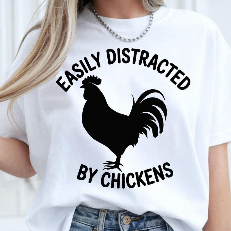 Funny Chicken Shirt, Easily Distracted By Chickens Shirt, Chicken Lover T Shirt, Rooster Shirt, Poultry Lover Tee, Farm Life Shirt, Backyard Chicken Shirt, Chicken Mum Shirt, Chicken Dad Shirt, Homestead Shirt, Country Living Tee, Chicken Gift, Farm Animal Shirt, Funny Farm Tee, Premium Graphic T Shirt by Teezora Prints, Poultry Apparel, Rural Lifestyle Shirt, Chicken Owner Tee, Chicken Graphic Shirt, Casual Farm Clothing, Barnyard Shirt, Chicken Farmer Shirt, Country Apparel, Animal Lover Tee.