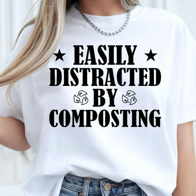 Perfect for gardeners, compost enthusiasts, plant lovers and anyone passionate about sustainable living, this Easily Distracted by Composting shirt adds humour to every gardening day. Whether you're working in the garden, managing an allotment or creating nutrient-rich compost, this premium graphic tee combines comfort with personality. Every shirt is professionally printed in the UK by TeezoraPrints for exceptional quality and long-lasting wear.