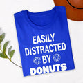 Perfect for coffee shop visits, bakery trips, food festivals, brunch dates, casual weekends, dessert outings, café meetups, holiday celebrations and everyday wear. This Easily Distracted by Donuts shirt combines humour, comfort and style, while every premium t-shirt is professionally printed in the UK by TeezoraPrints using premium-quality materials.