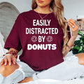 Funny donut lover shirt designed for bakers, dessert lovers, coffee drinkers, café visitors and food enthusiasts. Perfect for bakery trips, coffee mornings, brunch dates, food festivals and casual weekends. Every premium graphic t-shirt is professionally printed in the UK by TeezoraPrints, offering outstanding comfort, vibrant print quality and lasting durability.