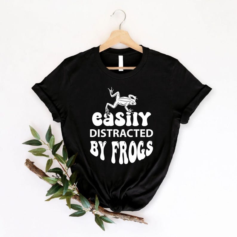 Funny frog lover shirt designed for amphibian enthusiasts, wildlife fans, hikers, campers and outdoor explorers. Perfect for nature reserves, woodland walks, pond visits, wildlife photography, eco events and casual weekends. Every premium graphic t-shirt is professionally printed in the UK by TeezoraPrints, delivering long-lasting comfort and vibrant print quality.
