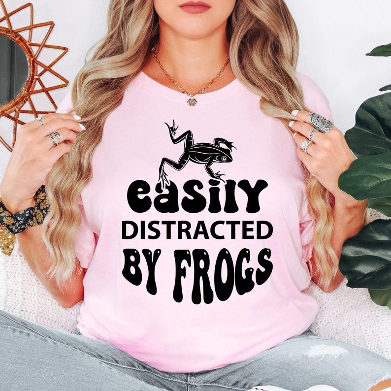 Perfect for hiking trips, camping weekends, nature walks, pond visits, wildlife parks, eco festivals, outdoor adventures and casual everyday wear. This Easily Distracted by Frogs shirt combines comfort, humour and style, while every premium t-shirt is professionally printed in the UK by TeezoraPrints using high-quality materials.