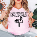 Funny mailbox lover shirt designed for postal employees, mail carriers, delivery workers, mailbox collectors and novelty clothing fans. Perfect for work, post office visits, delivery routes, casual weekends and everyday outfits. Every premium graphic t-shirt is professionally printed in the UK by TeezoraPrints, offering vibrant print quality and lasting comfort.