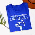 Perfect for delivery routes, post office work, employee appreciation events, retirement parties, casual Fridays, work celebrations, everyday wear and weekend outings. This Easily Distracted by Mailboxes shirt combines humour, comfort and style, while every premium t-shirt is professionally printed in the UK by TeezoraPrints using premium-quality materials.