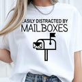 Easily Distracted by Mailboxes shirt, funny mailbox t shirt, postal worker tee, mail carrier shirt, USPS inspired apparel, mailbox lover clothing, delivery driver shirt, novelty work shirt, post office graphic tee and humorous everyday fashion. Every premium shirt is proudly printed in the UK by TeezoraPrints for comfort and lasting quality.