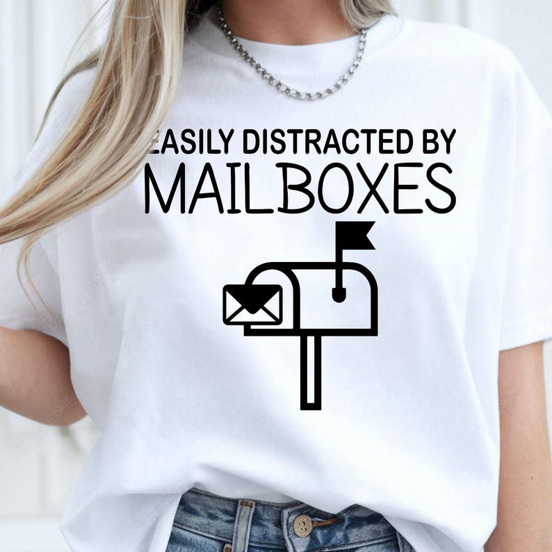 Easily Distracted by Mailboxes shirt, funny mailbox t shirt, postal worker tee, mail carrier shirt, USPS inspired apparel, mailbox lover clothing, delivery driver shirt, novelty work shirt, post office graphic tee and humorous everyday fashion. Every premium shirt is proudly printed in the UK by TeezoraPrints for comfort and lasting quality.