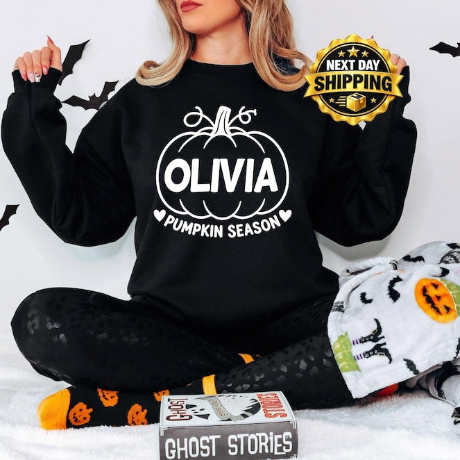 Personalised Pumpkin Season sweatshirt featuring a custom printed name and bold pumpkin artwork, designed as a fun autumn jumper for pumpkin picking, Halloween celebrations, seasonal photographs and cooler days. This personalised sweatshirt is a thoughtful custom clothing gift for mums, sisters, friends, daughters and anyone who enjoys autumn traditions and pumpkin season.