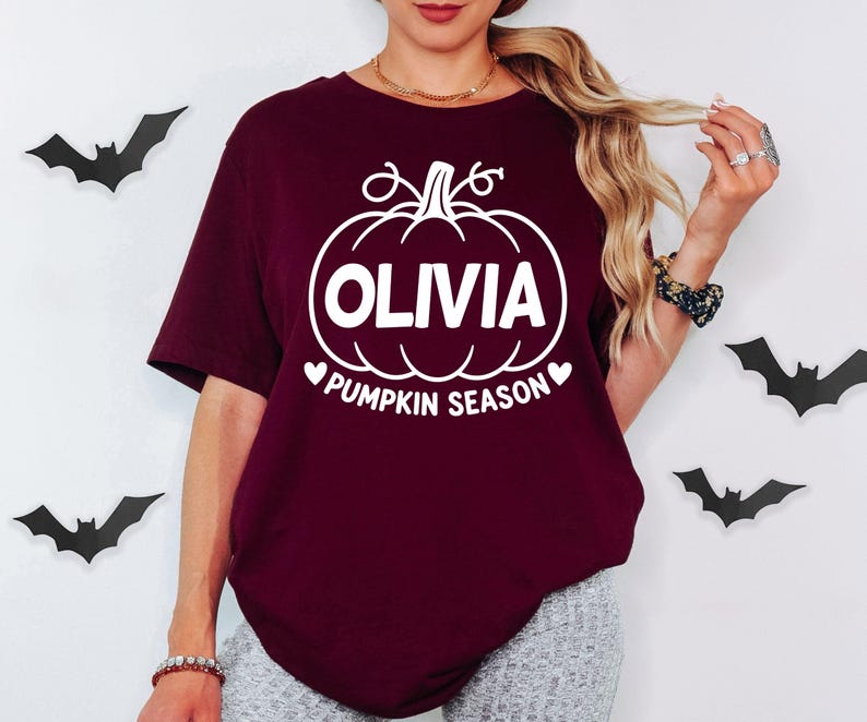 Personalised Pumpkin Season clothing featuring a custom printed name and classic pumpkin artwork, designed for autumn and Halloween lovers. Ideal for pumpkin picking, seasonal photos, Halloween events, autumn walks and casual everyday wear. A custom personalised T-shirt gift suitable for women, mums, sisters, friends and anyone who enjoys autumn traditions and pumpkin season.