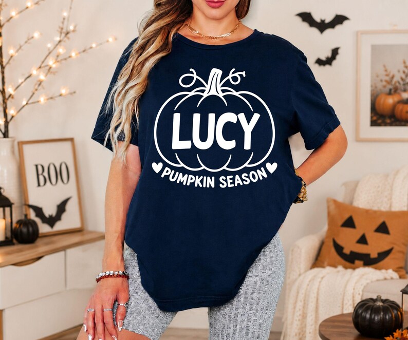 Custom name Halloween T-shirt featuring a pumpkin season design, personalised typography and an autumn-inspired theme. Perfect for women attending Halloween parties, pumpkin picking events, autumn gatherings and seasonal celebrations. This personalised shirt can also make a unique birthday, Halloween or autumn gift for mums, sisters, friends and family members.