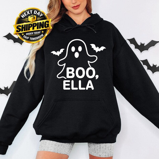 Personalised Boo Halloween hoodie featuring a cute ghost design with a custom name printed underneath, surrounded by spooky bat details, perfect for Halloween parties, trick or treating, autumn celebrations, personalised Halloween outfits and fun spooky season clothing gifts.